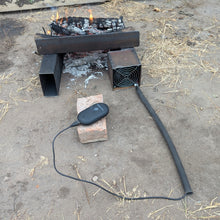 A DC being used in a campfire blowing hot air powered by using a common USB battery bank for hours of power. Sturdy enough it can support a dutch oven!